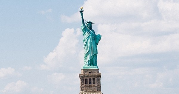 The Statue of Liberty against a cloudy sky.