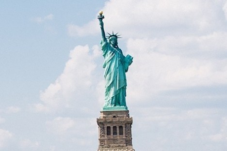 The Statue of Liberty against a cloudy sky.